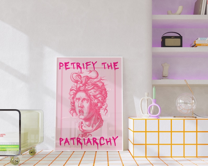 May include: A pink framed print with the text "Petrify the Patriarchy" in pink lettering. The print features a pink illustration of a woman's head with snakes in her hair.