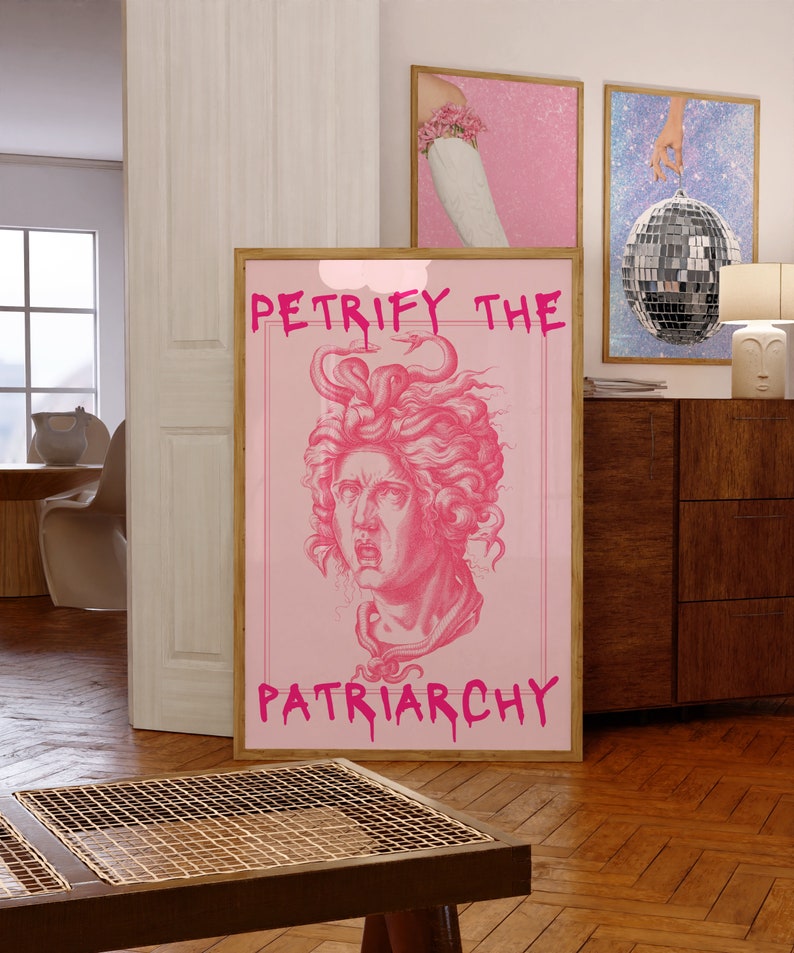 May include: Pink framed poster with a pink background and a black and white illustration of a woman's head with snakes in her hair. The text "PETRIFY THE PATRIARCHY" is written in pink dripping letters.