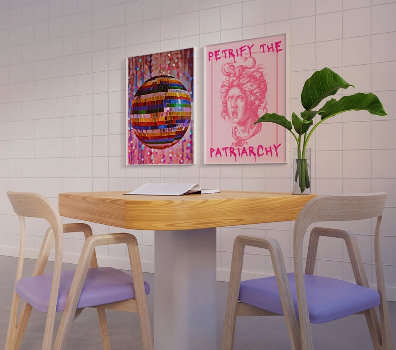 May include: Two posters on a white tiled wall, one with a disco ball and the other with a pink background and the text "Petrify the Patriarchy". A wooden table with two light purple chairs and a plant in a clear vase.