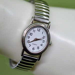 Silver tone with white dial, stretch bracelet, womens wrist watch