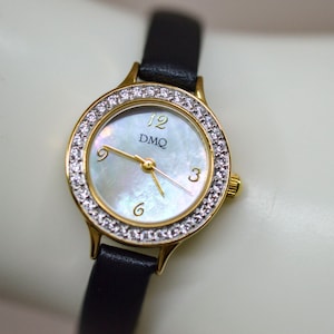DMQ, gold tone with crystals, mop dial, womens fashion wrist watch