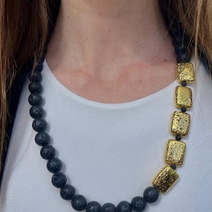 Handcrafted necklace in natural lava stone and gold-plated lava stone