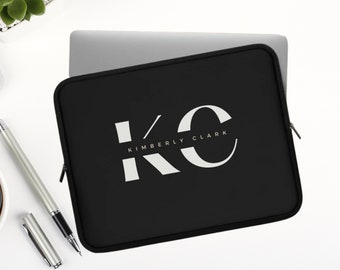 May include: Black laptop sleeve with a white zipper and the text "KC KIMBERLY CLARK" in white.
