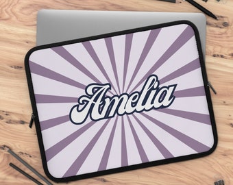 May include: Purple and white laptop sleeve with a sunburst design and the name Amelia in a white cursive font.