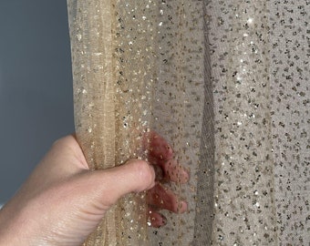 Glitter fabric on soft, stretchy mesh. Perfect material for evening dresses, sparkly accessories, ball gowns, and shawls.