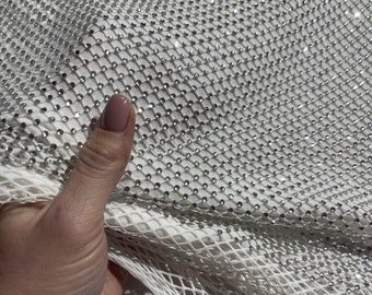 White netting, transparent crystals. Elastic fabric for wedding dresses, evening gowns, and accessories such as sleeves and corsets.