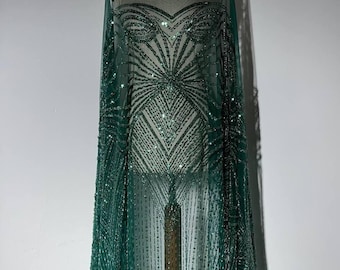 Densely embellished evening lace with sequins, beads, and pearls. Shimmering fabric for evening gowns, wedding dresses, and ball gowns.