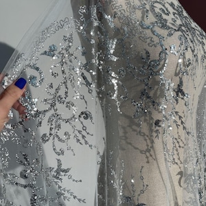 Delicate mesh, glitter particles, silver sequins, floral motif perfect for wedding dresses, ball gowns, evening dresses.