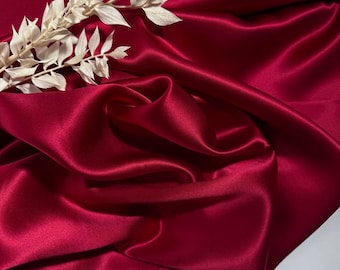 Silk satin with a delicate sheen. Natural silk for airy dresses. Soft burgundy fabric for silk dresses, shirts, and skirts