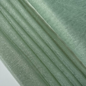 Shiny fabric with glitter. Soft glitter tulle for evening dresses. Eye-catching, airy fabric for sparkling accessories.