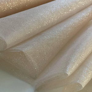 Shiny tulle with glitter particles. Soft glitter tulle, perfect for evening dresses, bridal accessories, wedding gowns, and veils.
