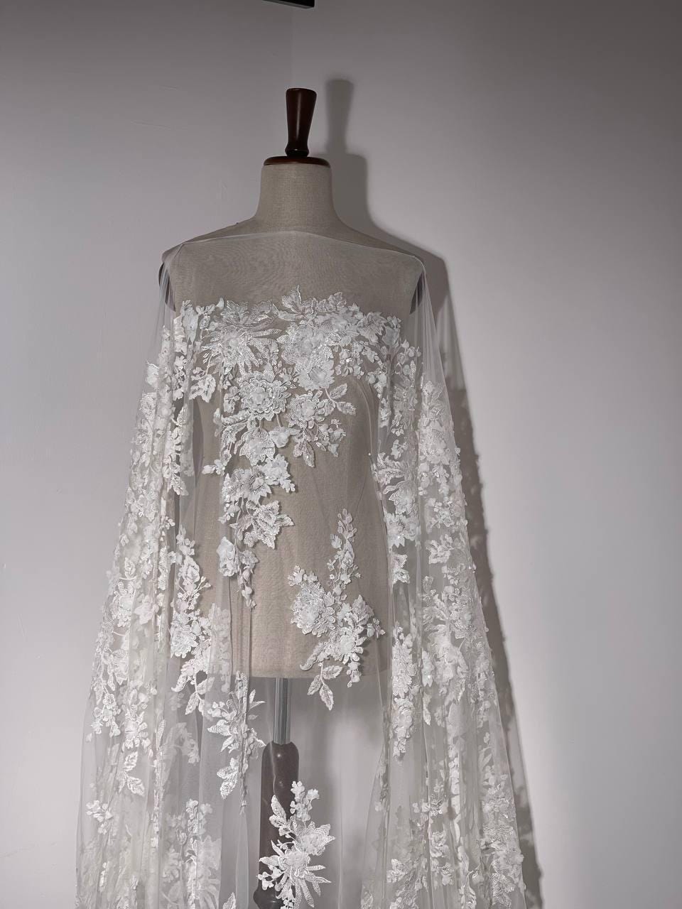 Handmade bridal lace, 3D floral pattern with delicate flowers, adorned with transparent sequins and beads, perfect for wedding dresses.