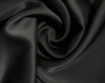 Natural silk fabric in an elegant black color. The material is airy and shiny, perfect for evening gowns, shirts, and skirts.