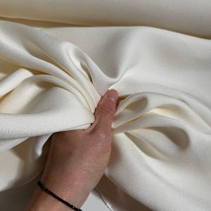 Luxury heavy weight silk crepe. Soft silk fabric. Elegant material for wedding dresses, suits, trousers, and skirts.