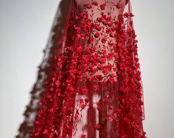 May include: Red sheer fabric with 3D floral embroidery. The fabric is covered in small, red flowers and has a sparkly finish.