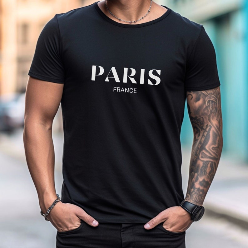 May include: Black t-shirt with white text that reads "PARIS FRANCE".