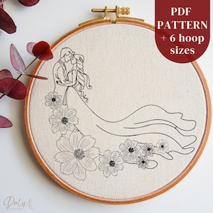 May include: Black and white line art embroidery pattern of a couple embracing with flowers at their feet. The pattern is displayed on a white fabric in a wooden embroidery hoop. The text "PDF PATTERN + 6 hoop sizes" is displayed in the top right corner of the image.