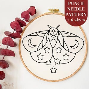 May include: A black and white line drawing of a moth with stars and crescent moons on its wings. The moth is in a round embroidery hoop. The text "PUNCH NEEDLE PATTERN + 6 sizes" is at the top of the image.