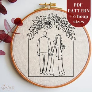 May include: A black and white embroidery pattern of a couple walking under a floral archway. The pattern includes a groom in a suit and a bride in a wedding dress. The text "PDF PATTERN + 6 hoop sizes" is in the upper right corner of the image.
