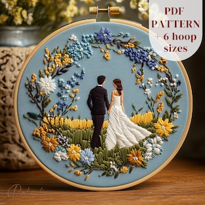 May include: Embroidered hoop art depicting a couple in wedding attire, surrounded by colourful floral details. The design includes yellow, blue, and white flowers, with the text "PDF PATTERN + 6 hoop sizes" on the upper right.