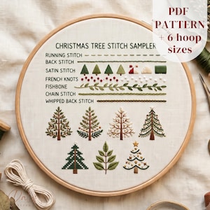 May include: A circular wooden embroidery hoop containing a white fabric sampler with the text CHRISTMAS TREE STITCH SAMPLER. It displays various embroidery stitches including running, back, satin, French knots, fishbone, chain, and whipped back stitches.