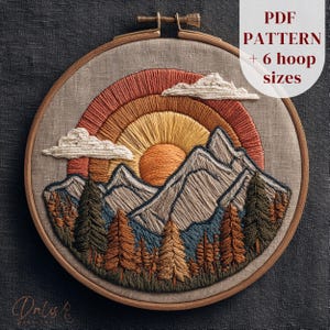 May include: Embroidered landscape art in a wooden hoop. The design features a sunset with a rainbow, mountains, trees, and clouds. The text "PDF PATTERN + 6 hoop sizes" is visible. The artwork is stitched with orange, yellow, brown, blue, and white thread.