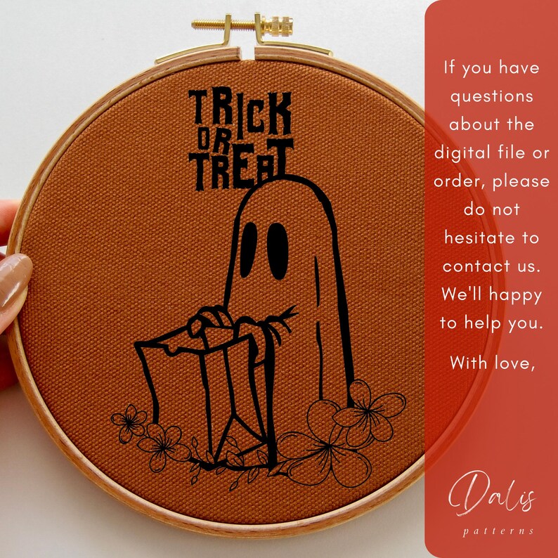 May include: A Halloween embroidery hoop with a ghost design and the words "TRICK OR TREAT". The black design is on burnt orange fabric, set in a wooden hoop. Floral accents are at the bottom. The text on the side is: "If you have questions..."