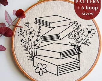 May include: A black and white embroidery pattern of a stack of books with flowers. The pattern is in a hoop and is ready to be stitched. PDF pattern includes 6 hoop sizes.