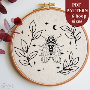 May include: Black and white embroidery pattern of a cicada with leaves and stars. The pattern is in a hoop and includes 6 hoop sizes. PDF pattern.