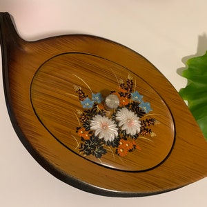 70s leaf shaped black lacquer Japanese trinket box with raised flower accents
