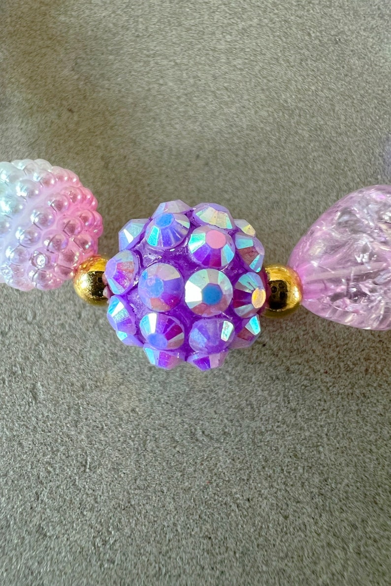 Kids necklace and bracelet set with purple butterfly charm.
