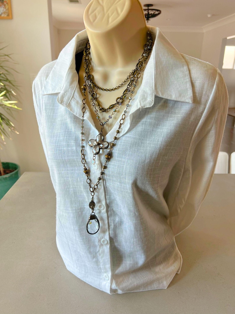 Layered necklace with clear glass crystal pendants.
