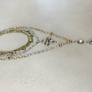 Layered necklace with clear glass crystal pendants.