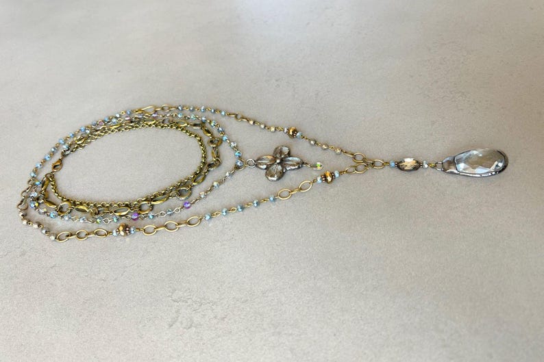 Layered necklace with clear glass crystal pendants.