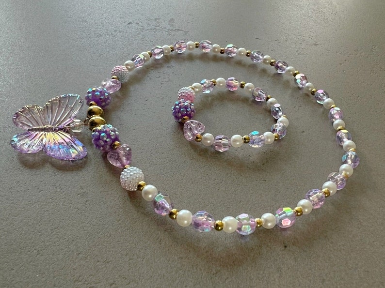 Kids necklace and bracelet set with purple butterfly charm.