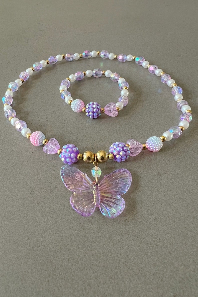 Kids necklace and bracelet set with purple butterfly charm.