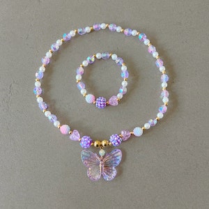 Kids necklace and bracelet set with purple butterfly charm.