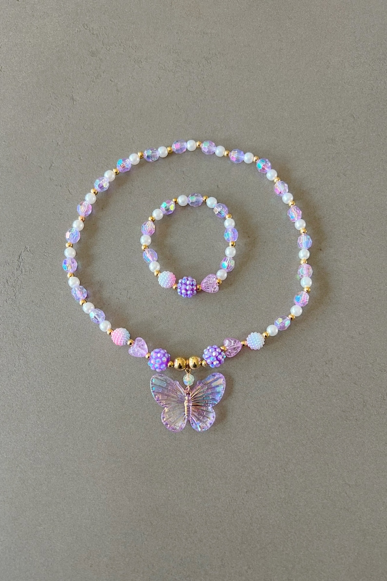 Kids necklace and bracelet set with purple butterfly charm.