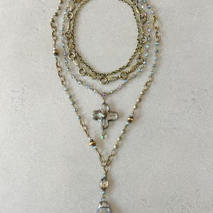 Layered necklace with clear glass crystal pendants.