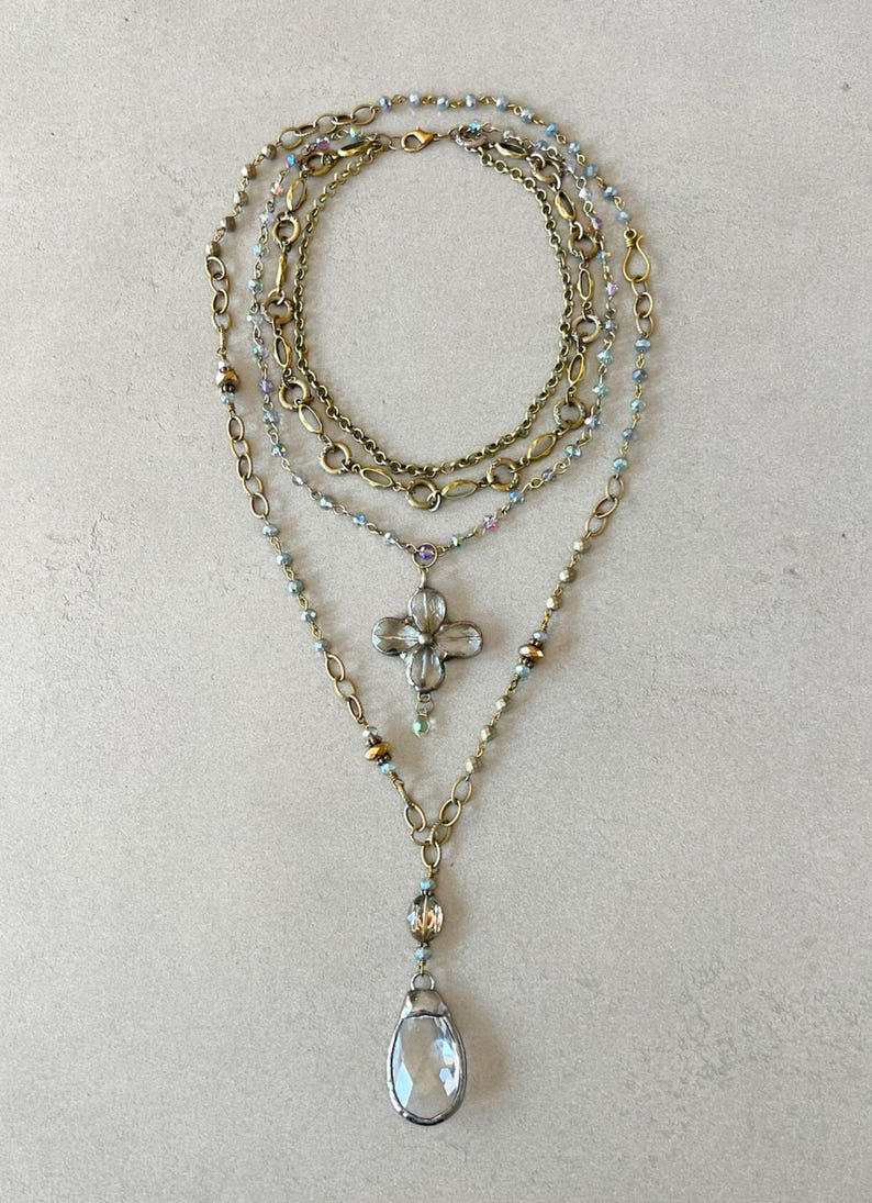 Layered necklace with clear glass crystal pendants.