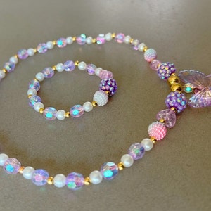 Kids necklace and bracelet set with purple butterfly charm.