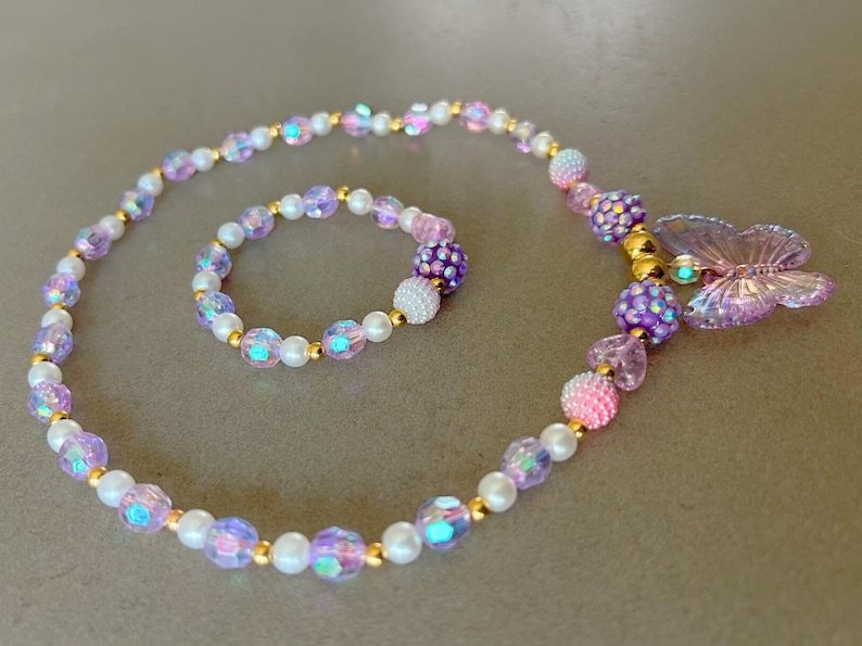 Kids necklace and bracelet set with purple butterfly charm.
