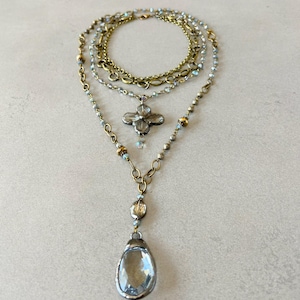 Layered necklace with clear glass crystal pendants.