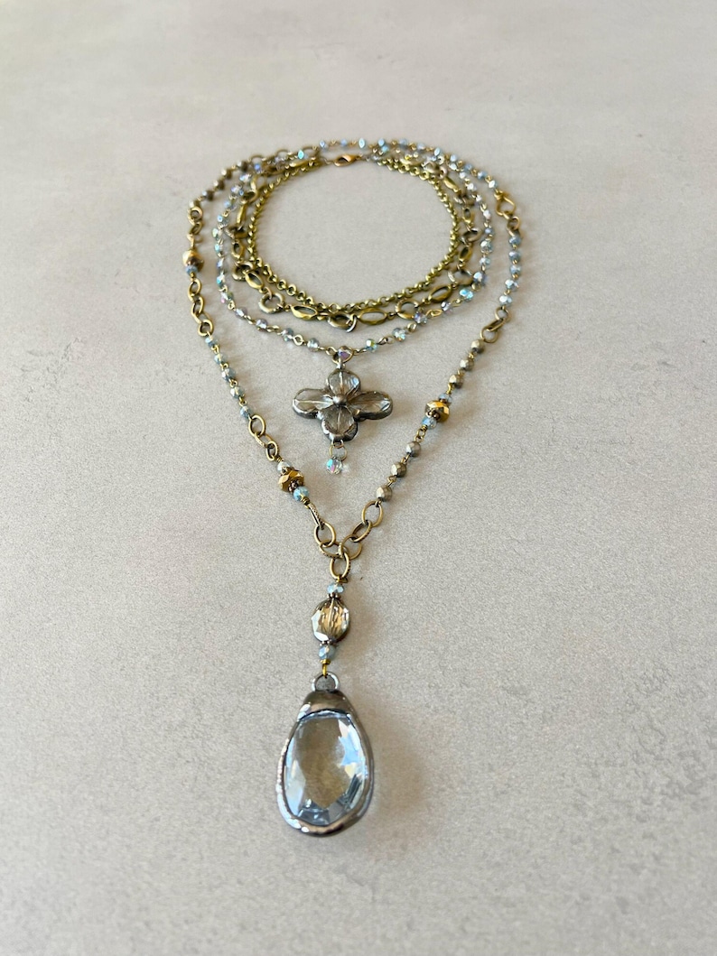 Layered necklace with clear glass crystal pendants.