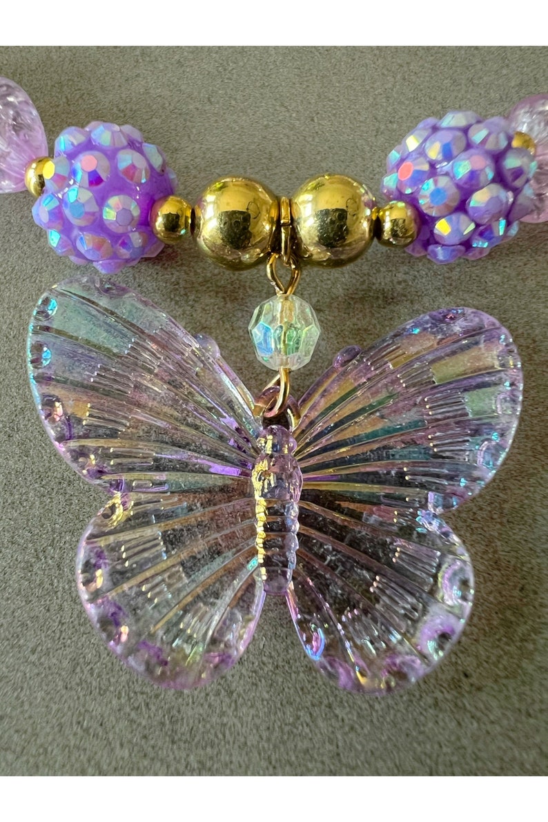 Kids necklace and bracelet set with purple butterfly charm.