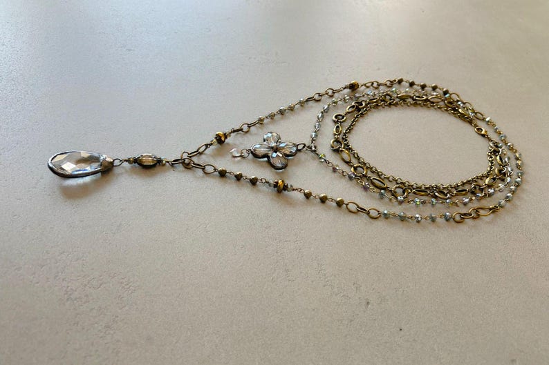 Layered necklace with clear glass crystal pendants.
