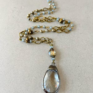 Layered necklace with clear glass crystal pendants.