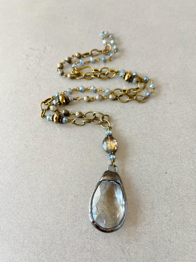 Layered necklace with clear glass crystal pendants.