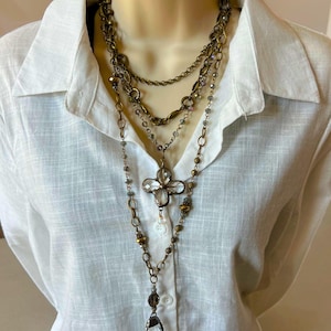 Layered necklace with clear glass crystal pendants.