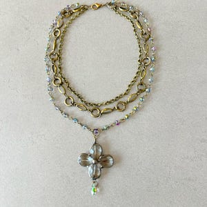 Layered necklace with clear glass crystal pendants.